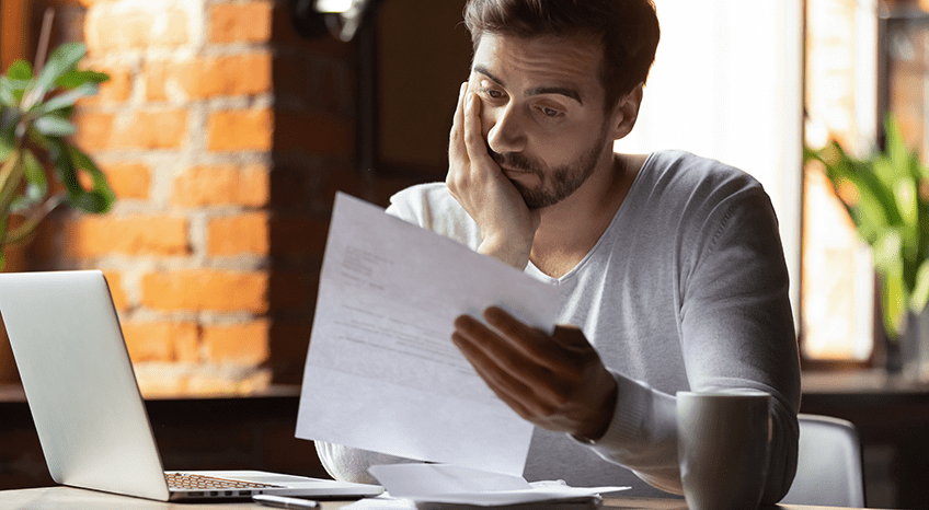 Man looks at paper unemployed